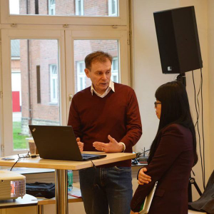 Warren Laine-Naida talking with a student